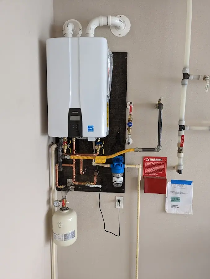 Professional plumber installing copper piping in a Jersey Village home